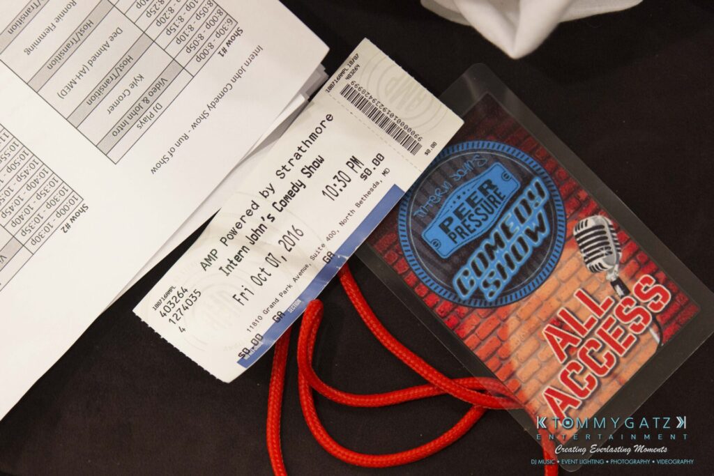 A ticket and an All Access pass for a comedy show are placed on a paper. The pass has a microphone and "Free of Pressure Comedy Show." The ticket is dated October 21, 2016.