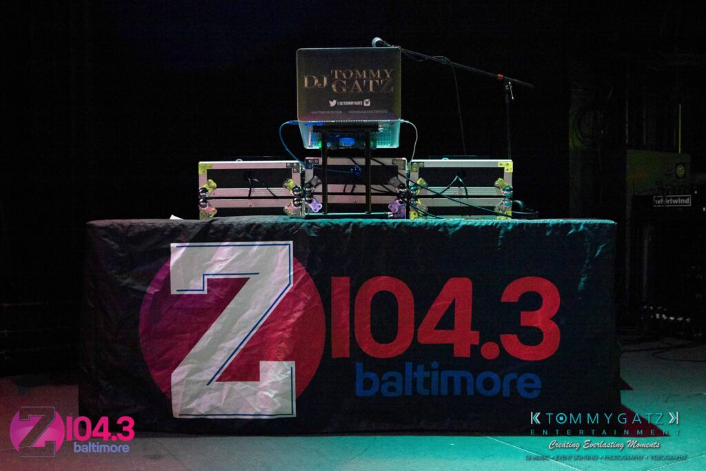 DJ setup on stage with a black tablecloth displaying "Z 104.3 Baltimore" and "KTOMMY GATZ ENTERTAINMENT" logos.